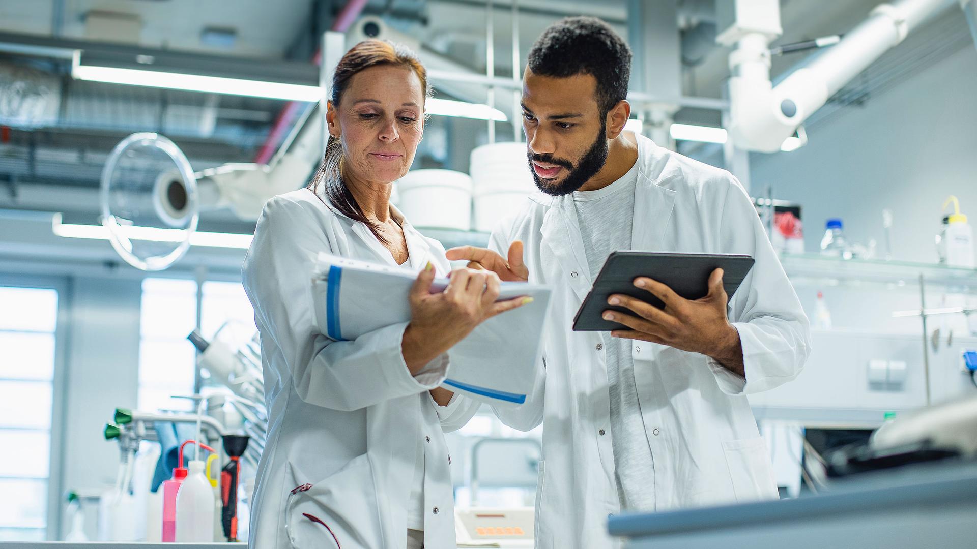 Two medical professionals conferring in a lab.