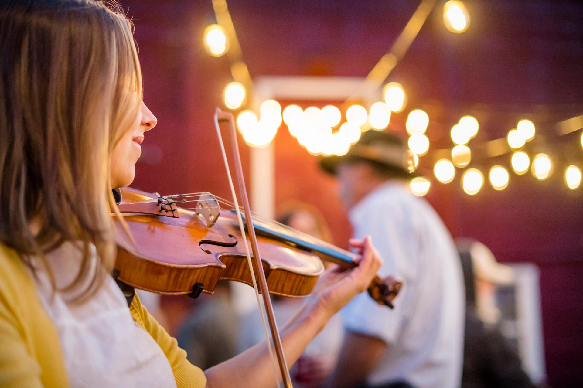 Bodrhan (Celtic drum) and fiddle musicians parade between locations