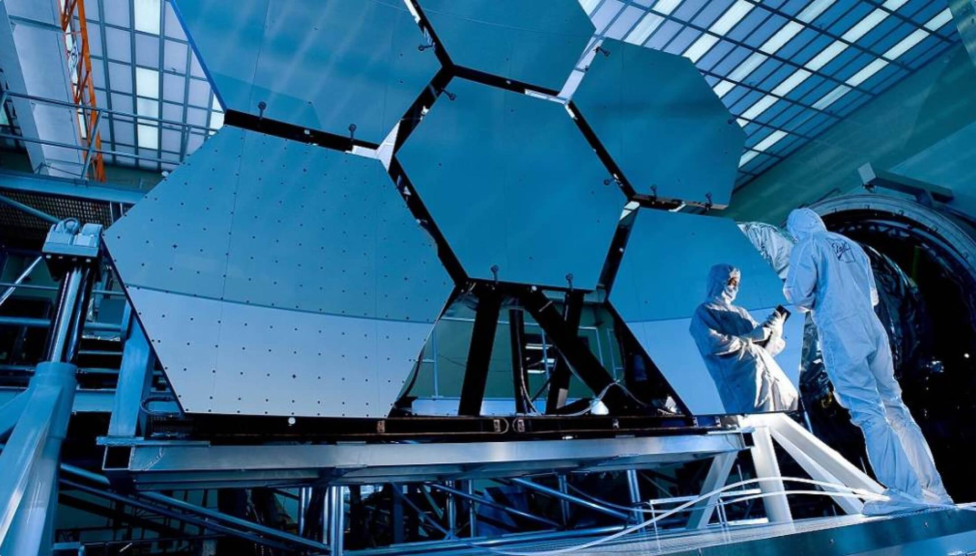 A scientist inspects a group of large industrial panels