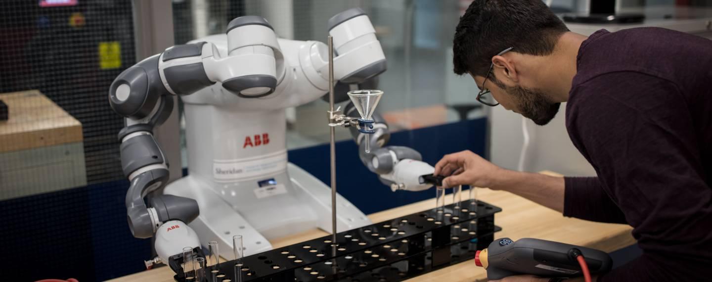A scientist works with machinery