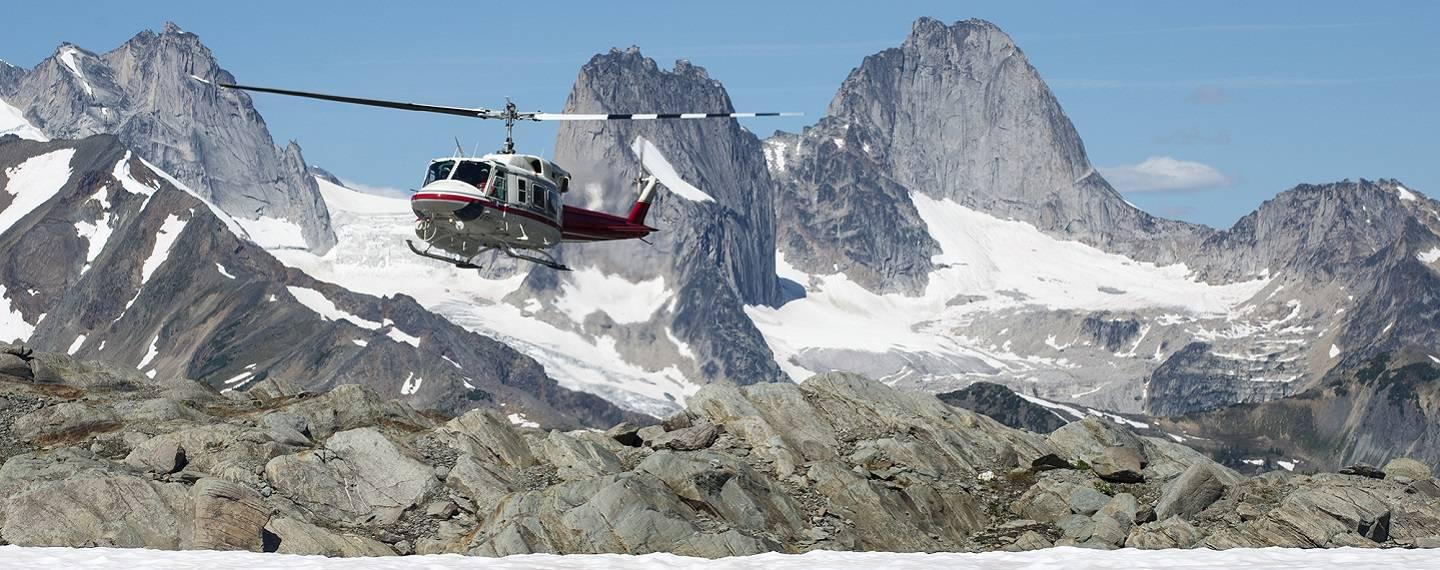 A Helicopter flies through the mountains