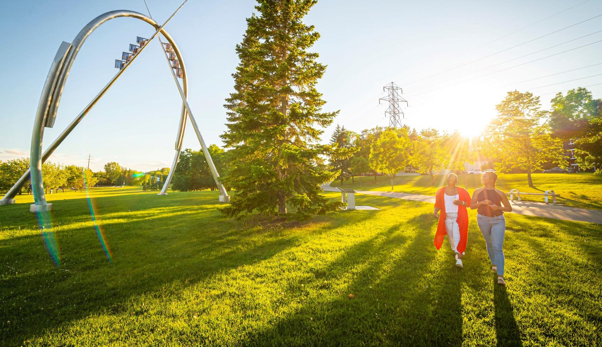 two people walking through a park
