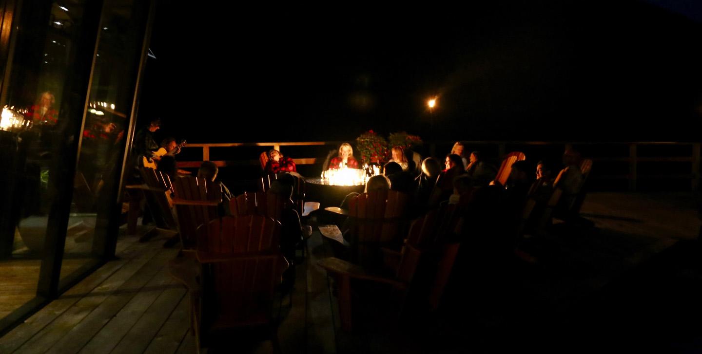 Watching sparks fly up from a roaring campfire as everyone joins in a sing-along