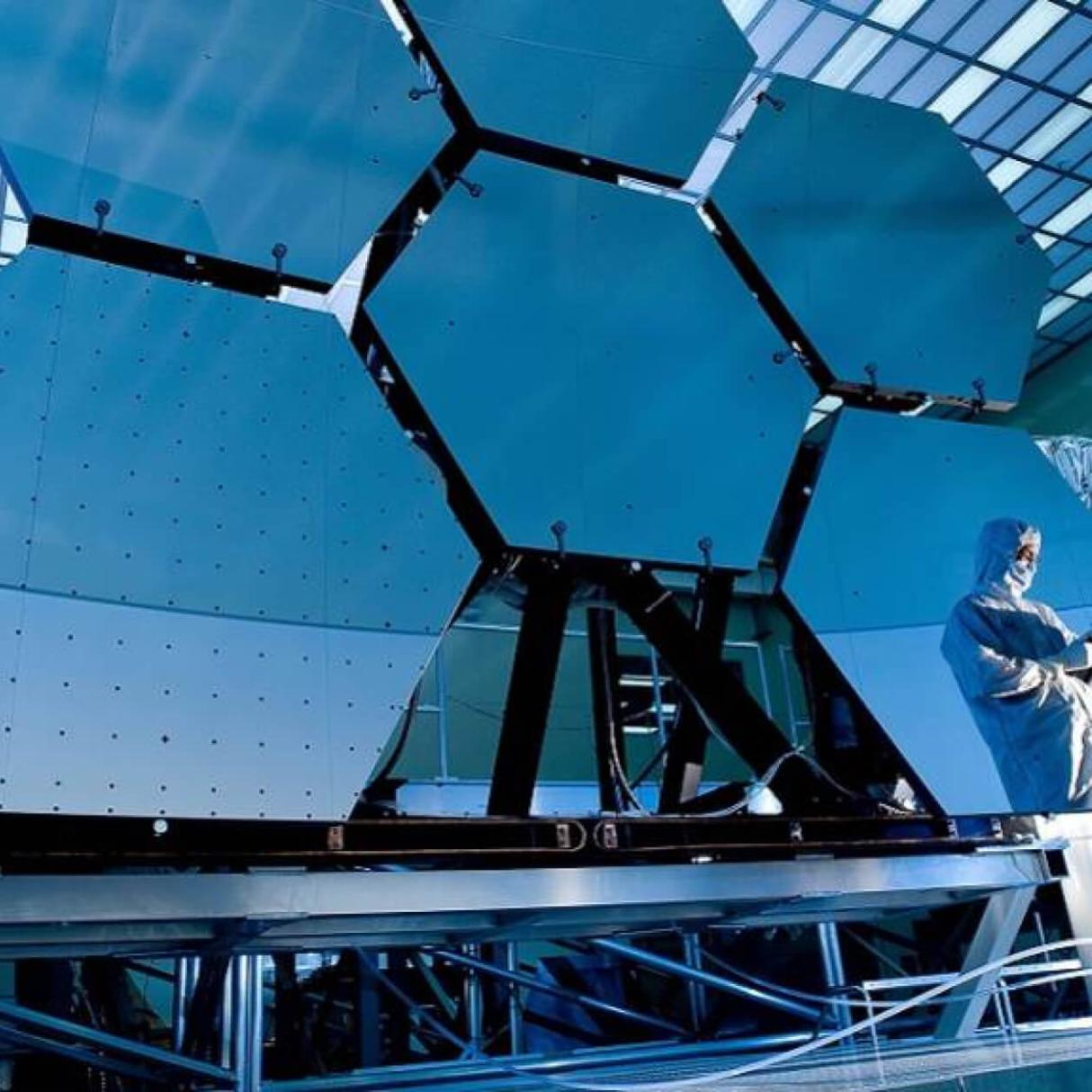 A scientist inspects a group of large industrial panels