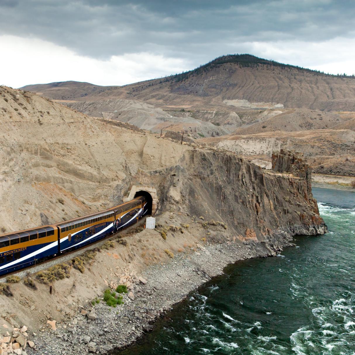 The Rocky Mountaineer train traveling through a mountain tunnel