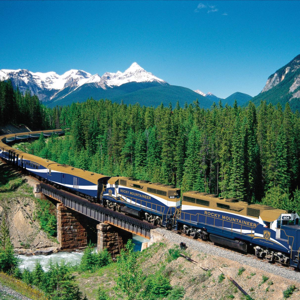 The Rocky Mountaineer train traveling over a rail bridge