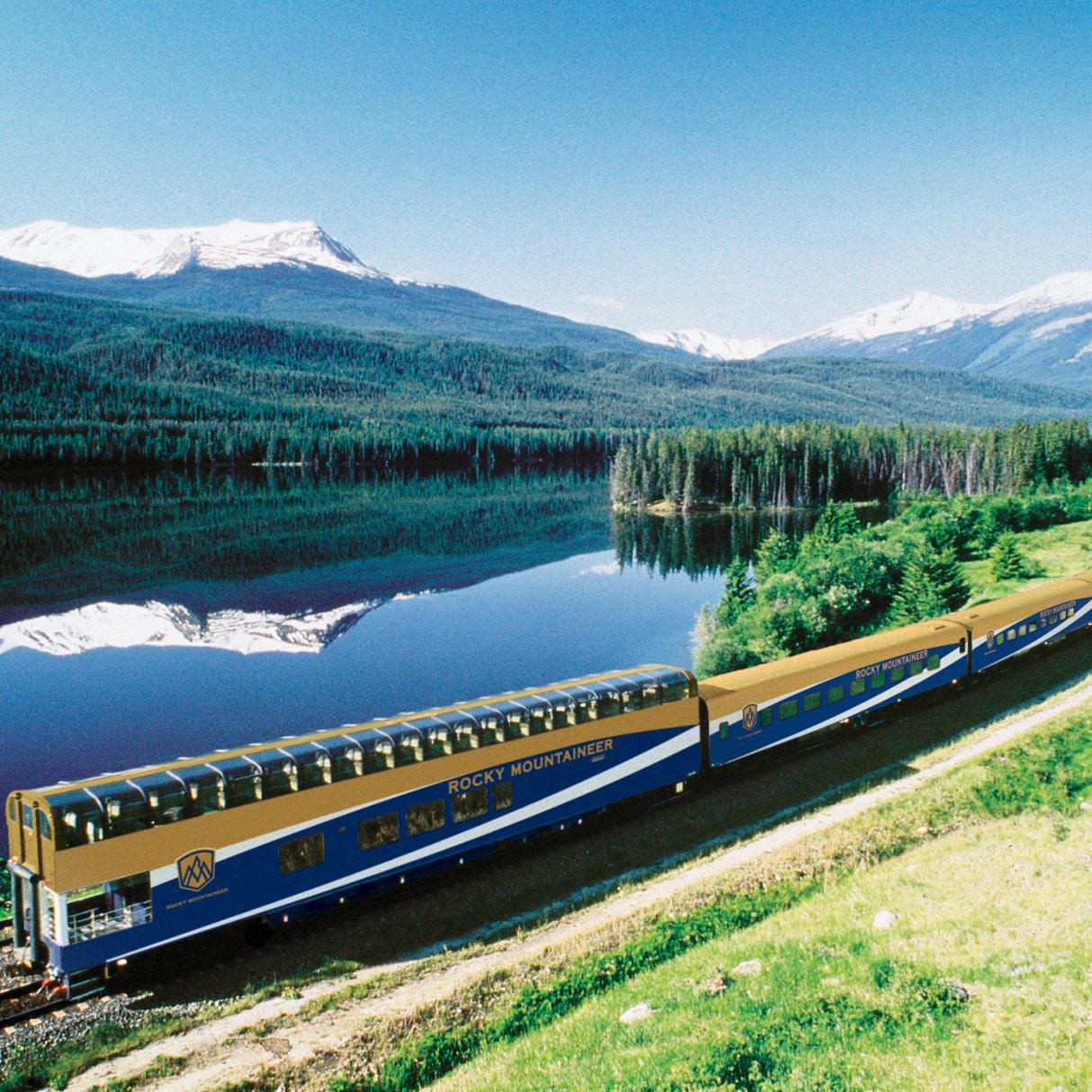The Rocky Mountaineer train traveling near a lake